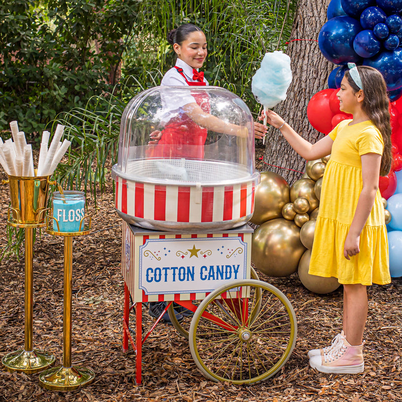 Circus Eats attendant giving a young girl cotton candy