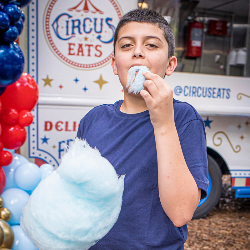 boy eating cotton candy