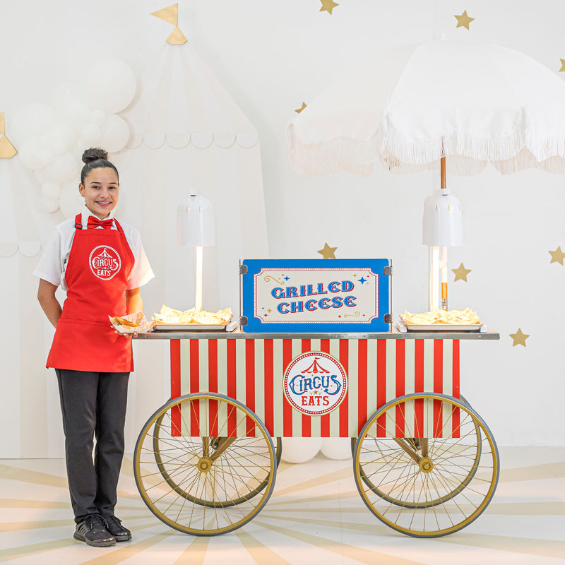 grilled cheese station with uniformed attendant and umbrella